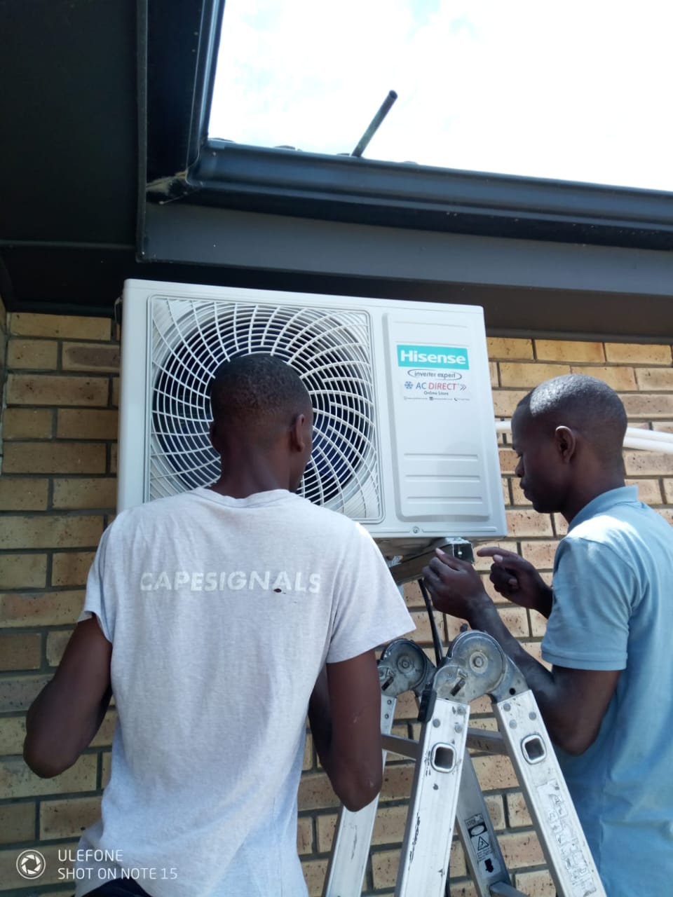 Deltar Electrical team mounting and connecting an outdoor unit